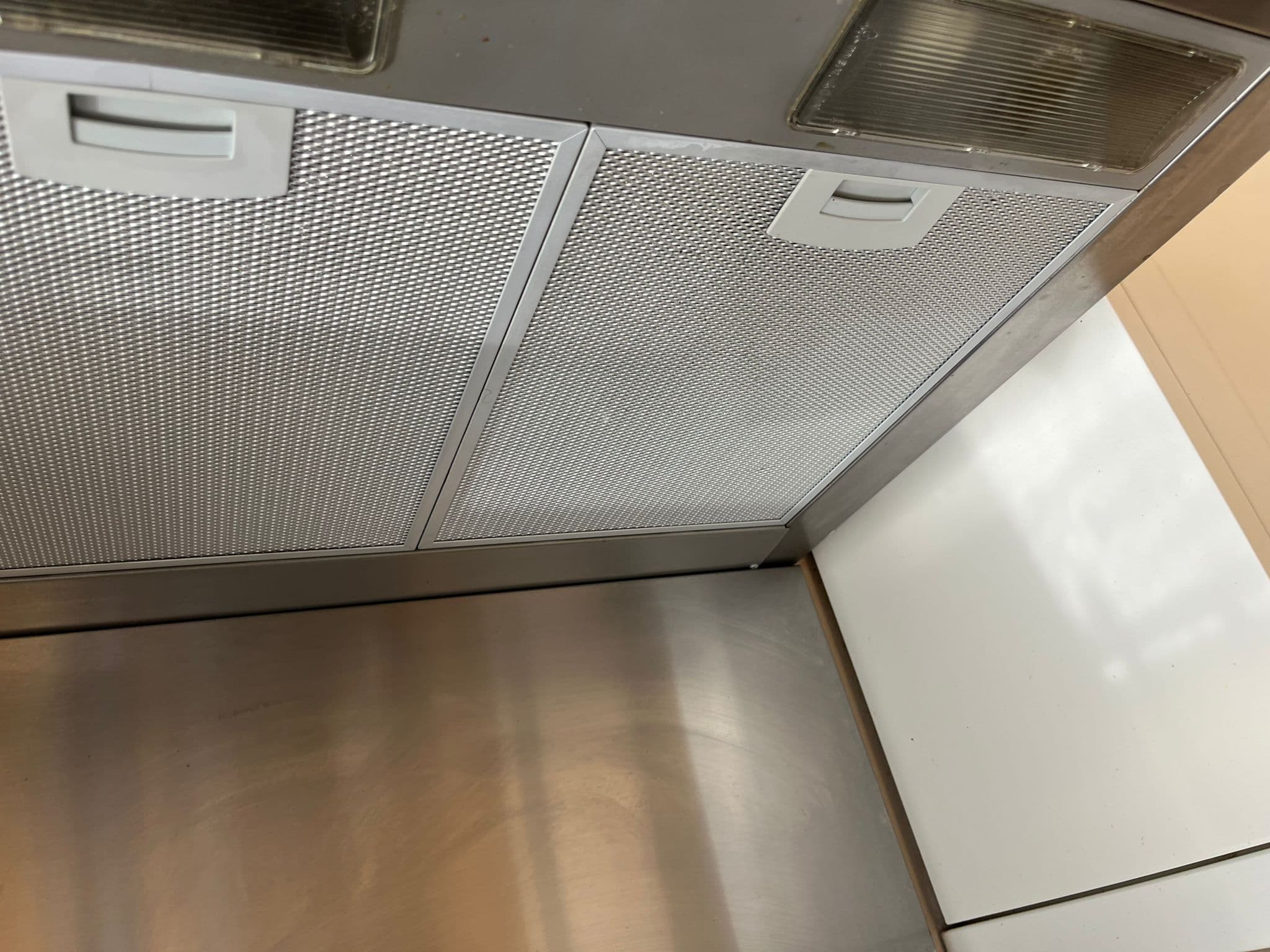 Degreased, clean metal extractor hood filters after cleaning