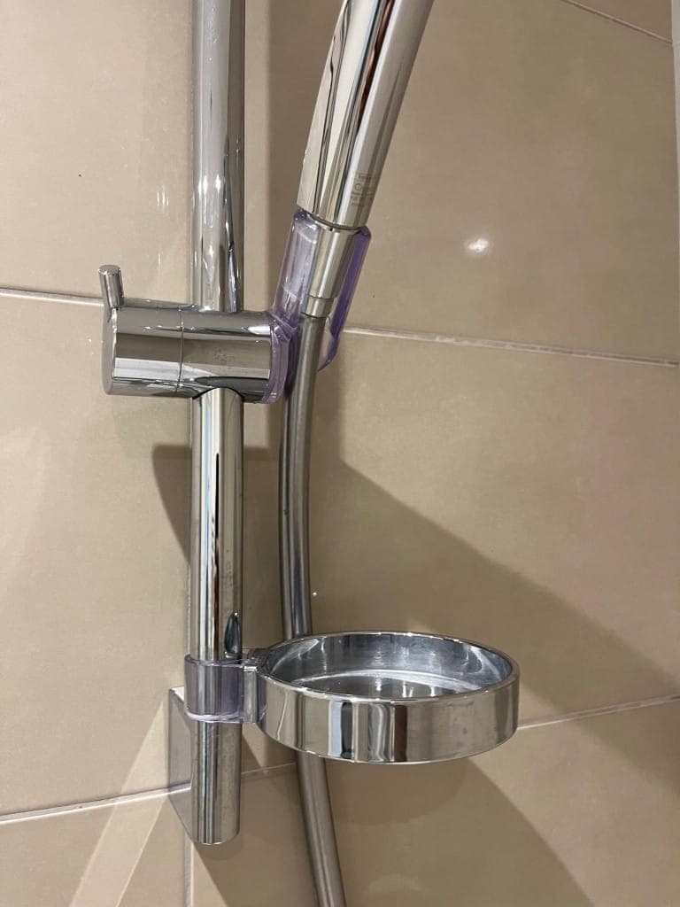 Shower rail after cleaning: chrome riser rail, bracket and soap dish descaled and polished to a shine
