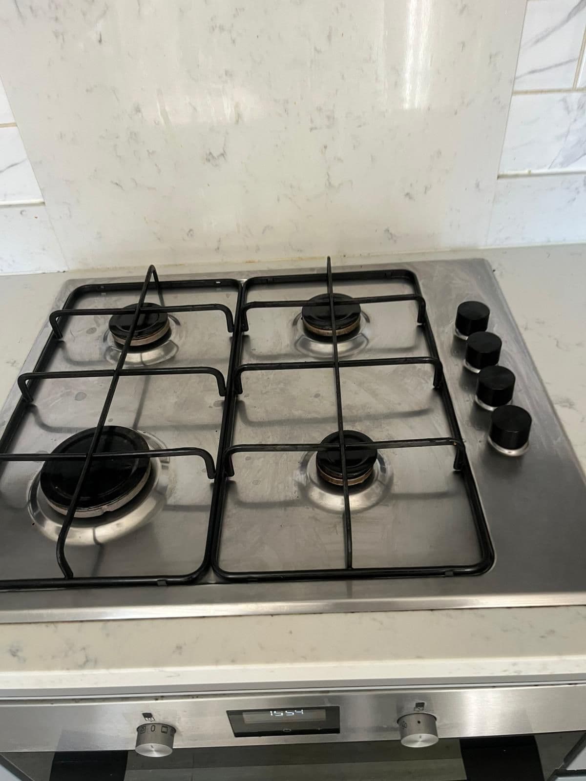 The same gas hob cleaned with polished burners and a clean stainless surround
