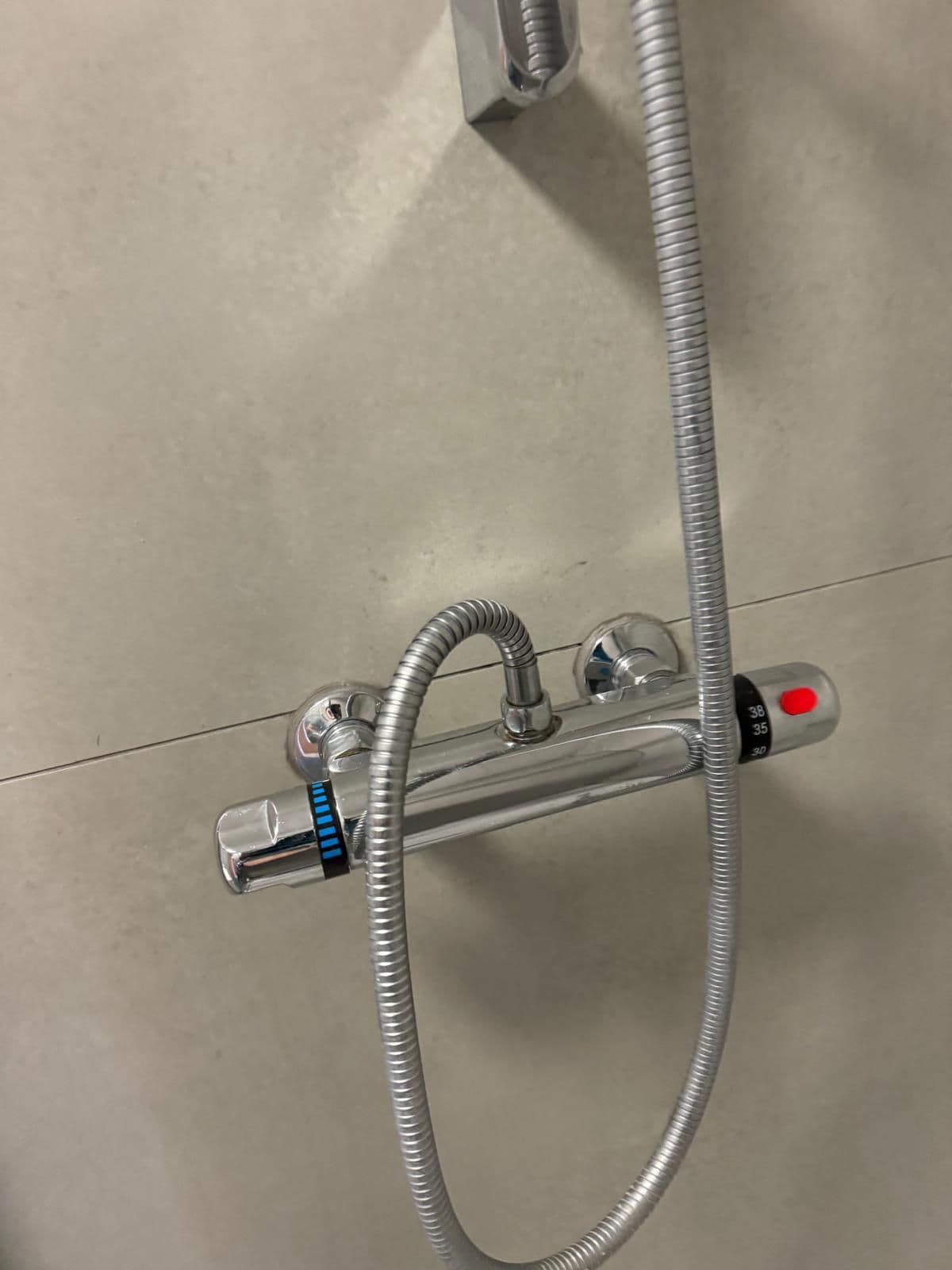 The same chrome shower mixer descaled and polished to a shine after cleaning